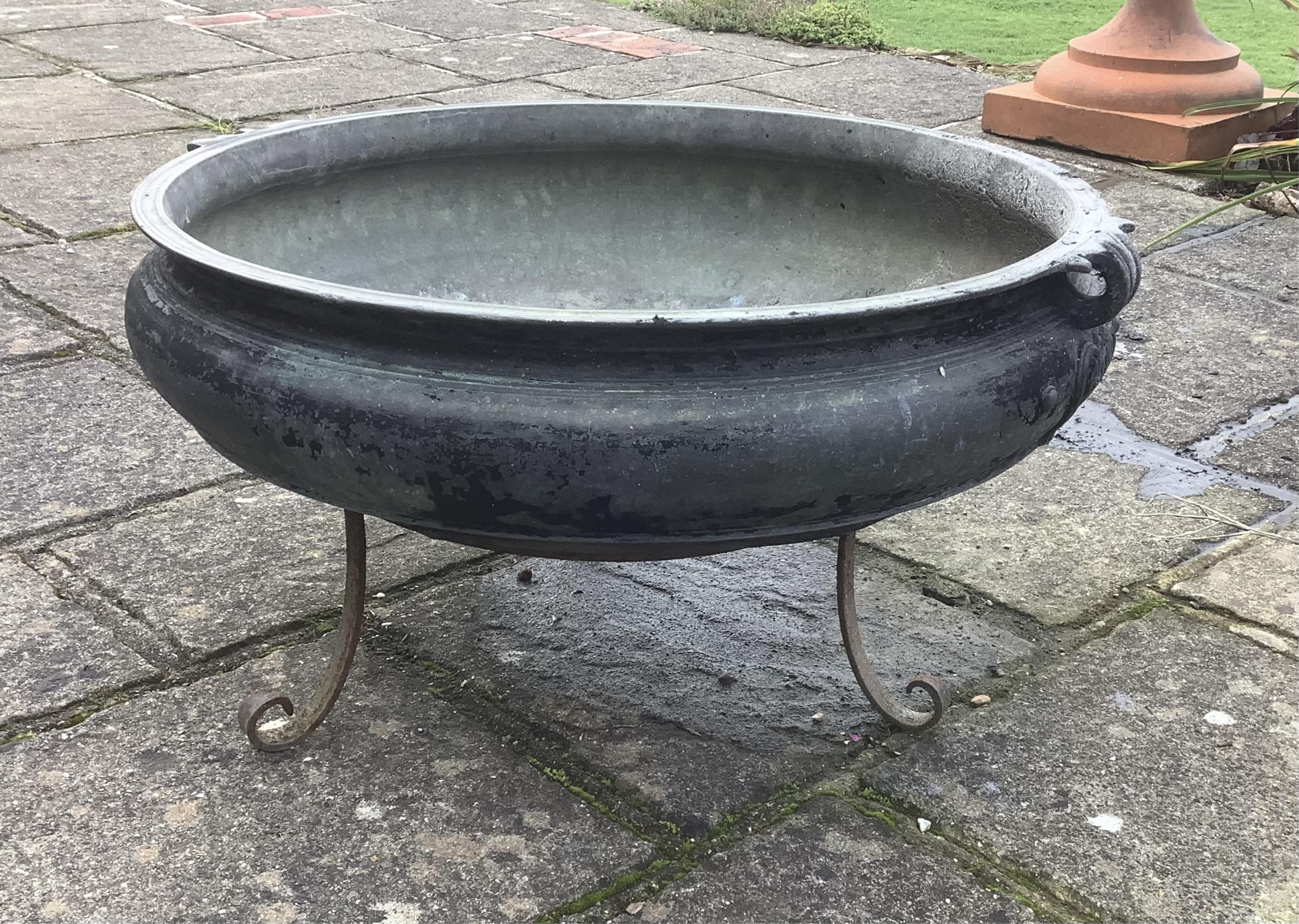 A large Indian bronze incense burner on wrought iron stand, width 79cm, 42cm high overall. one hole drilled. Condition - weathered, otherwise good